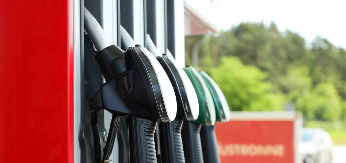 Row of gas pumps at a gas station with a blurred background
