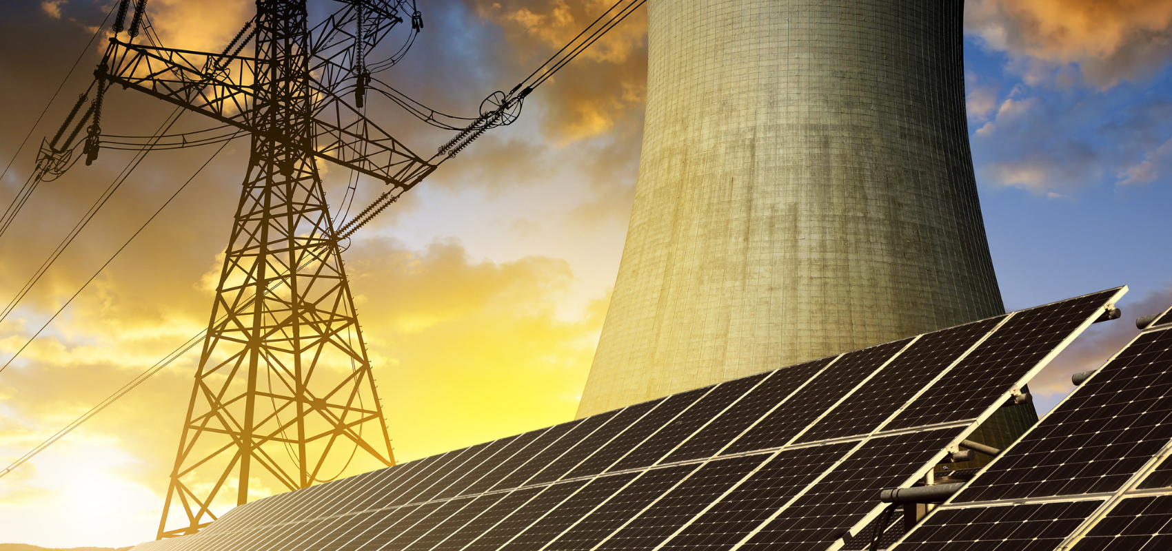 Solar panels with a power transmission tower and cooling tower in the background.